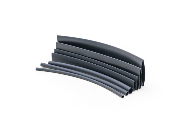 Multiple sizes of black heat shrink tubing stacking beside each other
